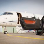 woman convertible car and corporate private jet airplane
